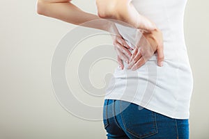 Backache. Young woman suffering from back pain