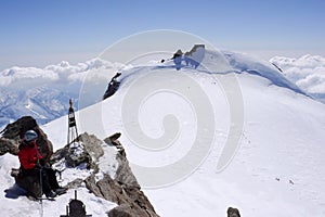 Backcountry skier and mountain climber on the summit of Zumsteinspitze in the Alps of Switzerland on a winter day