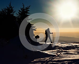 Backcountry skier reaching the summit