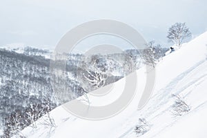 Backcountry skiing steep slope off the back of Niseko Mountain