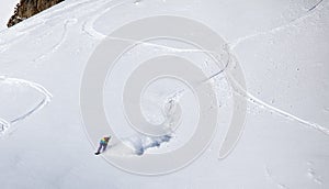 Backcountry snowboarder riding fresh powder