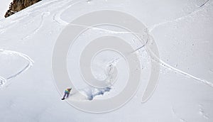Backcountry snowboarder riding fresh powder photo