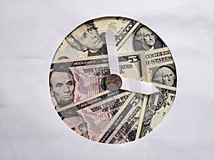 banknotes and coin of american dollar with paper forming clock figure, background and texture photo