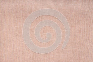 Light pink fabric texture - close-up on a piece of salmon pink linen fabric