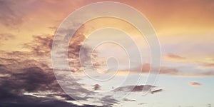 Backdrop. Light clouds contrast with dark clouds in the sunset sky.  Multicolored clouds