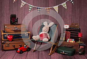 Backdrop with vintage decor and accesories like suitcases, books, typewriter, chair