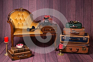 Backdrop with vintage decor and accesories like suitcases, books, typewriter, chair