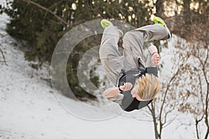 Backflip parkour jumping in winter snow park - free-run training photo