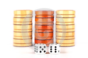 Backgammon dice and wooden checkers isolated on a white background