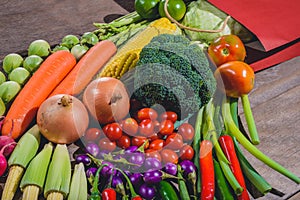 Backgroud of fresh food tasty and healthy many vegetables come out of paper shopping bag on the wooden table