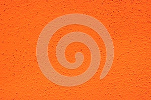 close up of neon bright semi smooth Safety Orange stucco wall texture background