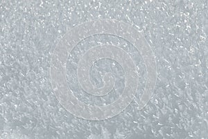 even sparkling white pure snow crystal flakes background close up background