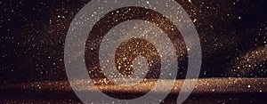 Background of abstract gold and black glitter lights. defocused