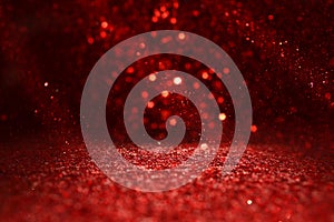 Background of abstract red, gold and black glitter lights. defocused