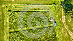 Background aerial asset of farmer mowing green field of assorted plants