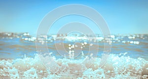 Background aquamarine of the Black Sea water surface in summer, waves glare and sparkle in the sun, rays, bokeh effect. Natural
