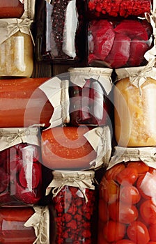 Background from assortment of canned vegetables and fruits- food in plastic free jars on wooden rustic table, flat lay