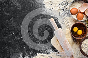 The background of baking. rolling pin, flour, egg, dough.