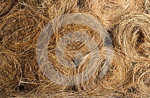 Background of bales hay stacked on each other