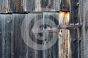 Background of bard wood slats and rusty hinge