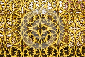 Background beautiful gilded ornamental grille gate