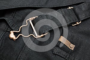 Background of black denim with copper elements and seams