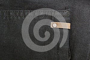 Background of black denim with copper elements and seams. Space for text