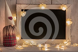 Background with blackboard for Christmas texts with lights and gnomes
