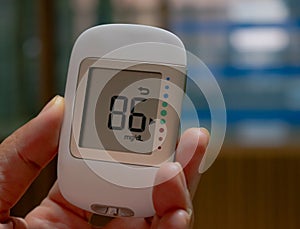 Digital handheld blood sugar detector use to measure patient blood sugar in the hospital. photo