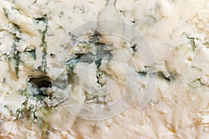 Background of blue cheese with blue-grey mold on cut