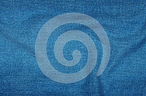 Background of blue denim with folds