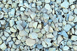 Background of blue and gray gravel. Small stones lie on the ground at a construction site. Pebble pattern on the beach