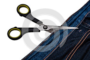 Background from blue jeans and a pair of scissors isolated on white background