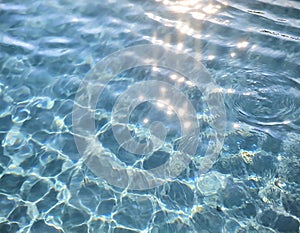 background of the blue sea water surface with sun rays and lens flare. AI-generated image