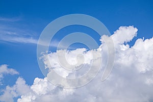 Background of blue sky with bright white fluffy clouds