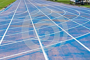 background of blue track for running competition at stadium, focus on center