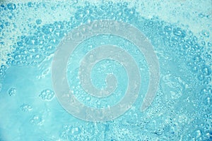 Background of blue water with foam and bubbles