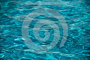 Background of blue water in swimming pool with sun reflection, ripple water wave in pool. Clear water background.