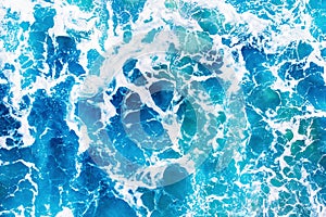 Background blue water texture with wave crest. Concept ocean top view