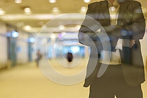 Background blur color tone warm in the morning. walkway Inside the building there are people. Foreground is a man wearing a suit.