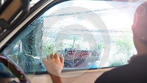 Background blur of service worker wrapping a car film on window