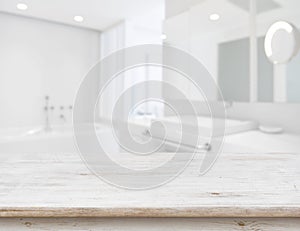 Background of blurred bathroom interior with wooden table in front