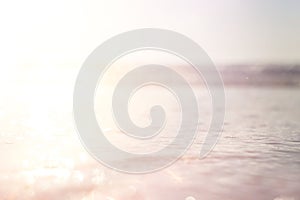 background of blurred beach and sea waves with bokeh lights