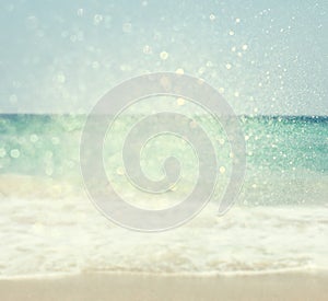 Background of blurred beach and sea waves with bokeh lights, vintage filter