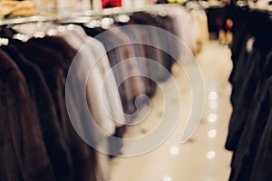 Background Blurred Defocused A row of vintage coats made of animal fur.