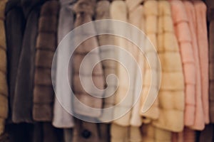 Background Blurred Defocused A row of vintage coats made of animal fur.