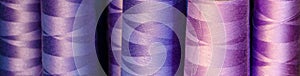 Background - bobbins of blue and purple threads