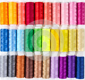 Background from bobbins with multicolored thread