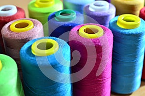 Background of bobbins with multicolored threads for sewing. Needlework, sewing and tailoring concept.