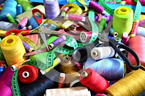 Background of bobbins with multicolored threads for sewing. Needlework, sewing and tailoring concept.